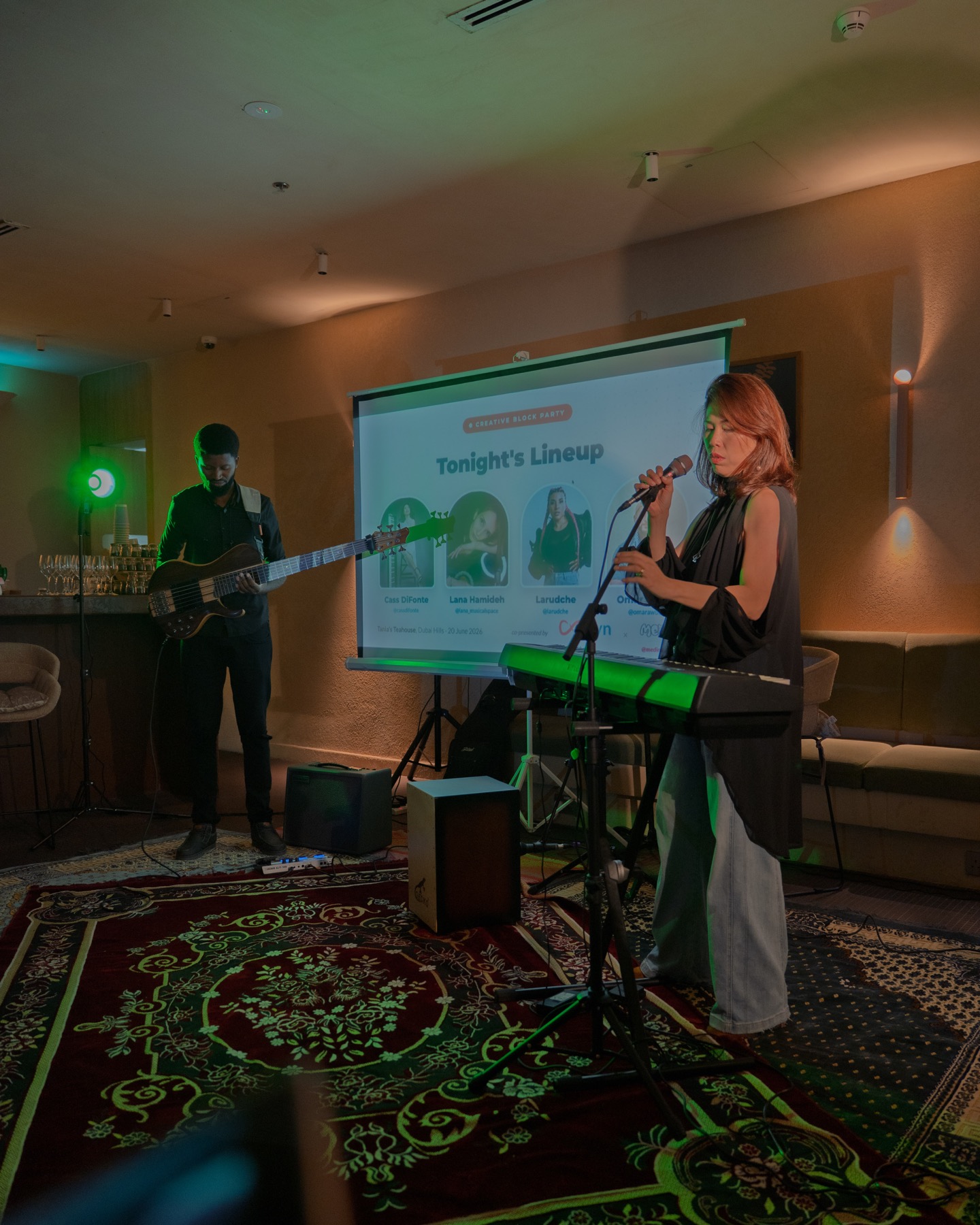 A singer and bassist performing live on stage