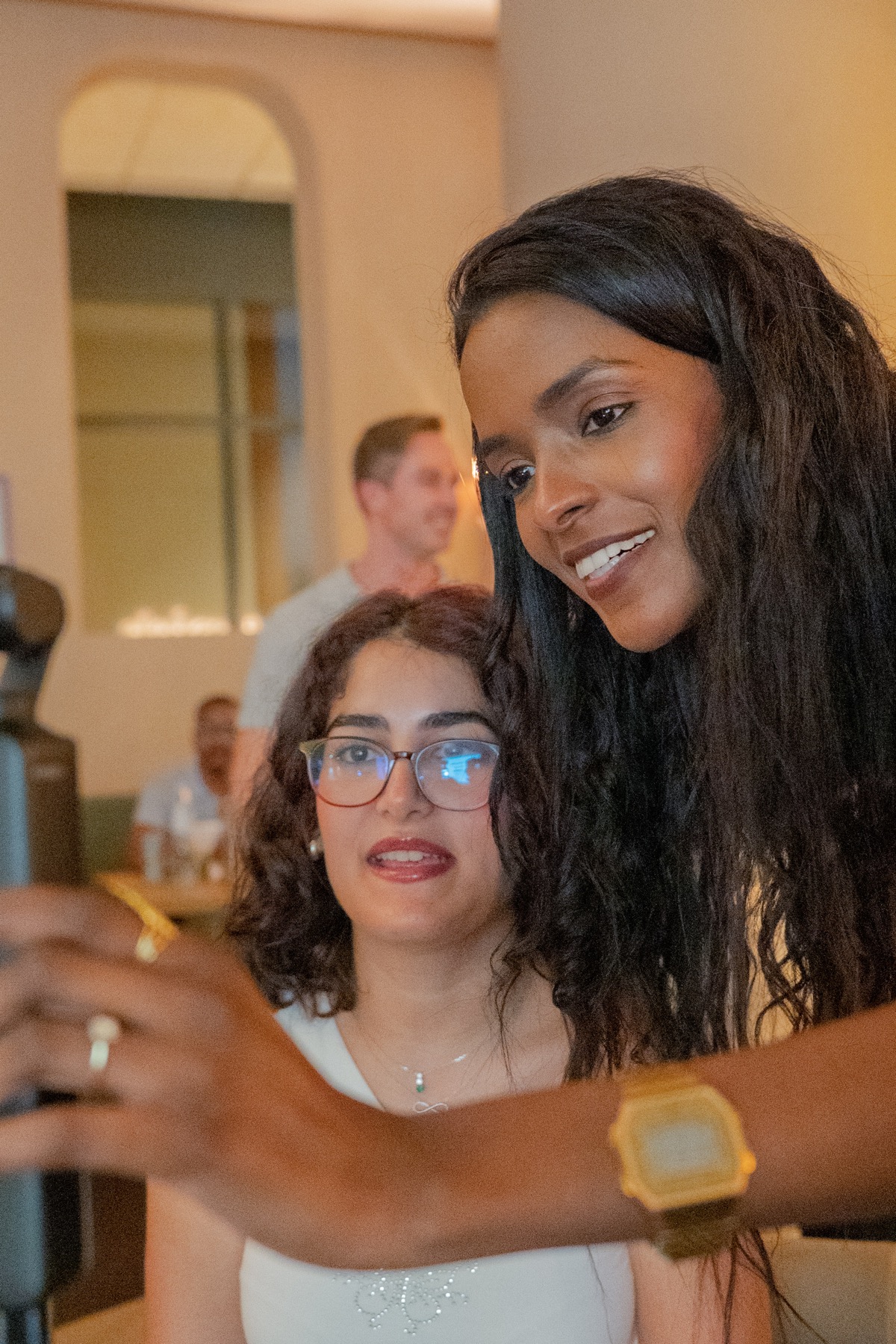 Sahar Ali taking a photo with a guest