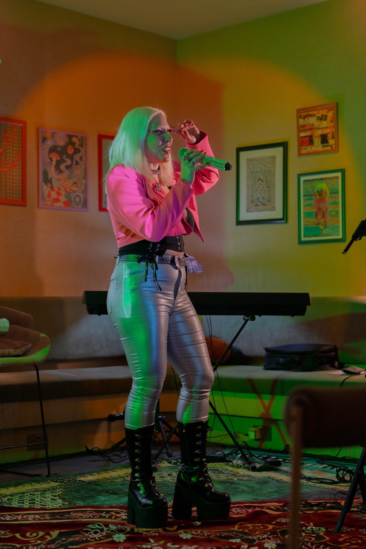 A singer performing in a bright pink jacket